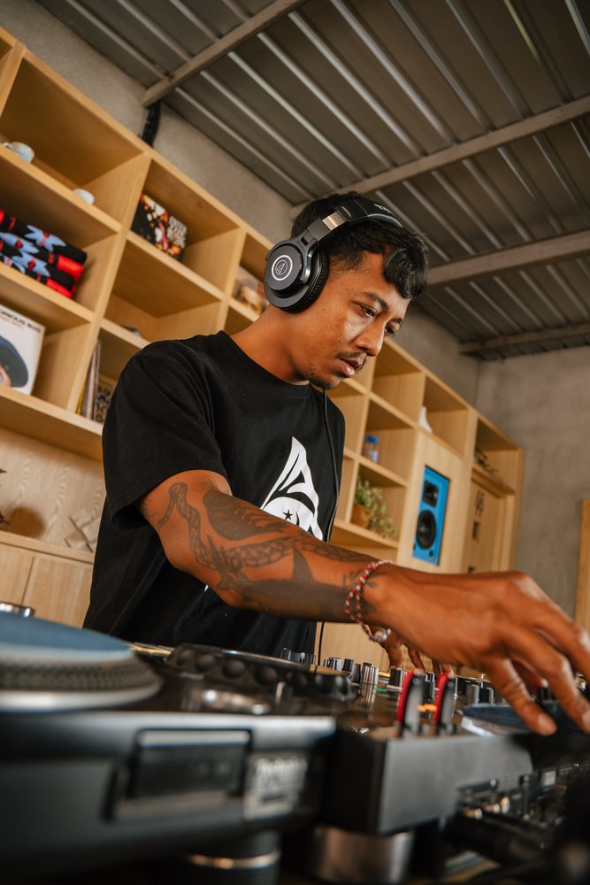 DJ playing a morning vinyl set during The Coffee Run at Micrology Canggu